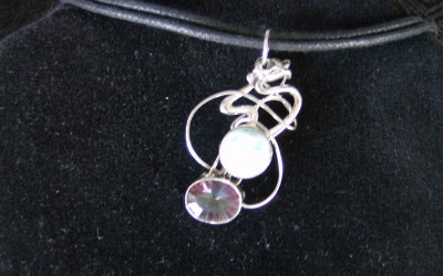 Modern design, sterling silver, larimar and mystic topaz pendant on cotton cord adaptable to chain or omega. SOLD