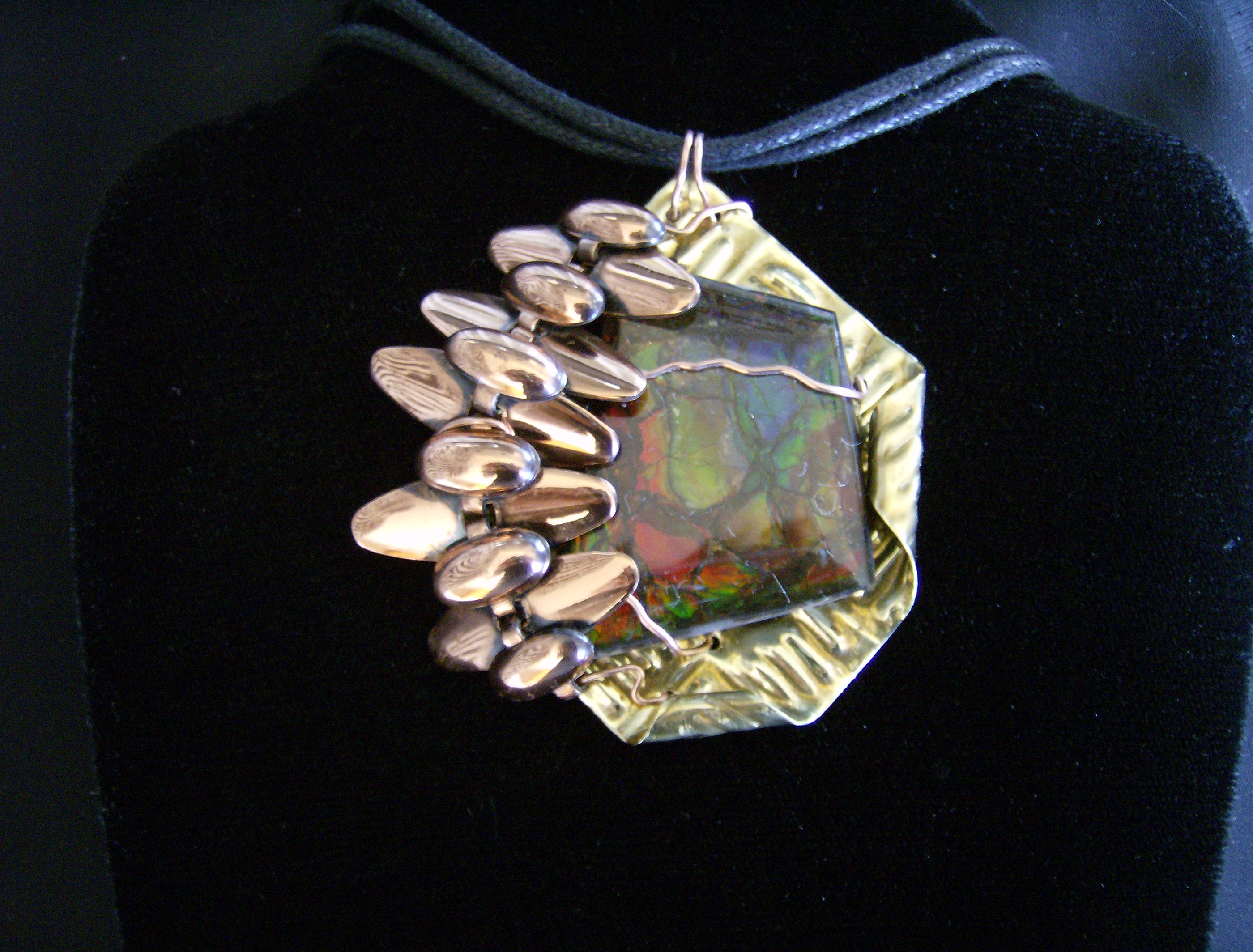 Modern design, Ammolite, brass, copper pendant on cotton cord adaptable to chain or omega. SOLD