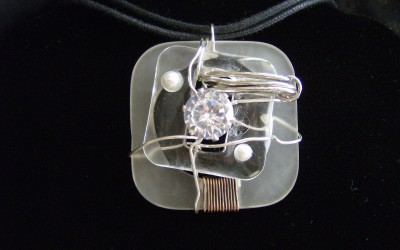 Modern, abstract design, Cubic Zirconia, lucite, pearl pendant on cotton cord adaptable to chain or omega. SOLD