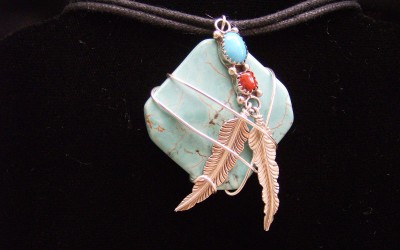 Native design, sterling silver, turquoise, coral & magnesite stone pendant on cotton cord adaptable to chain or omega.$125.00 USD
